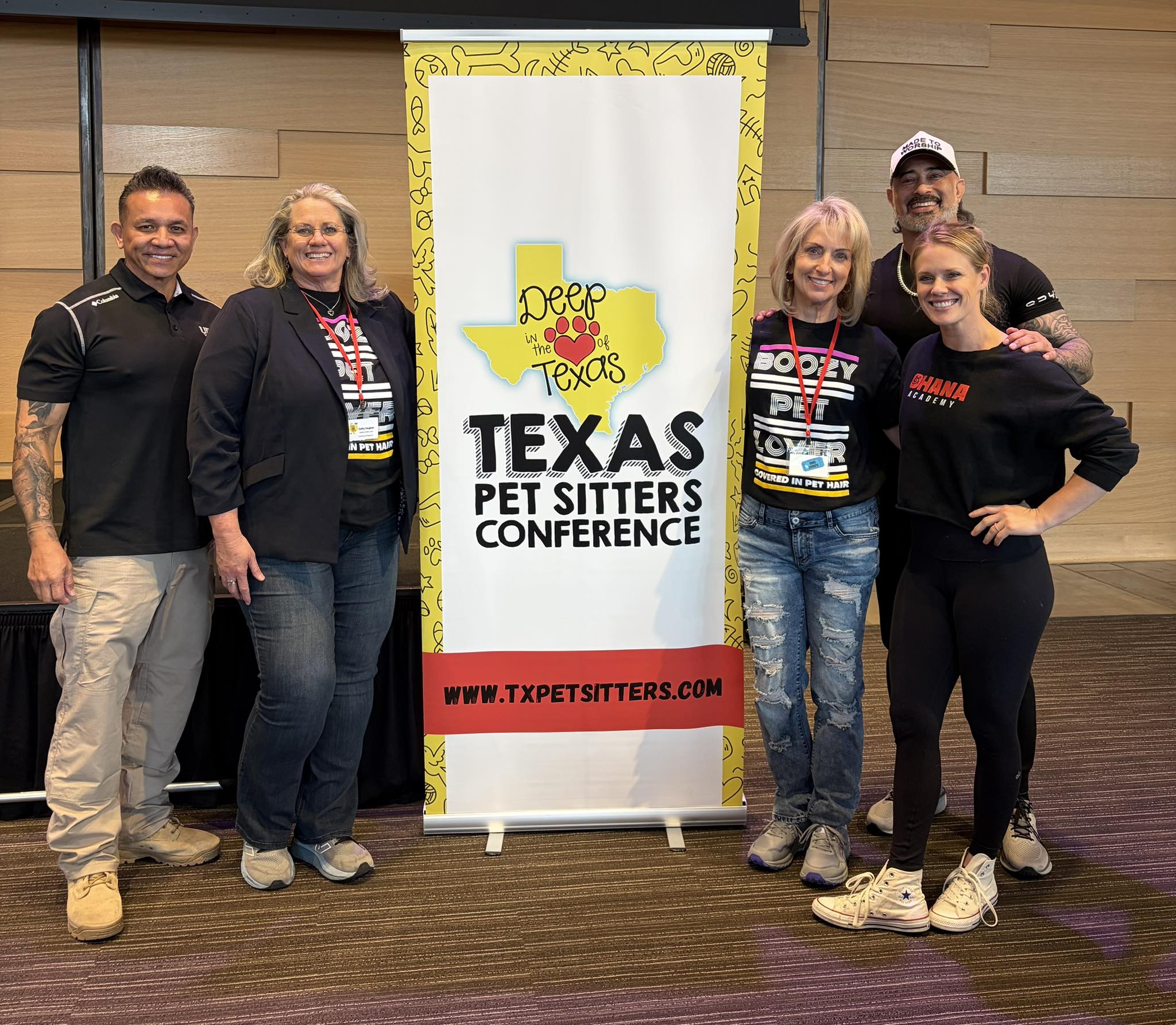 Attendees posing with conference banner
