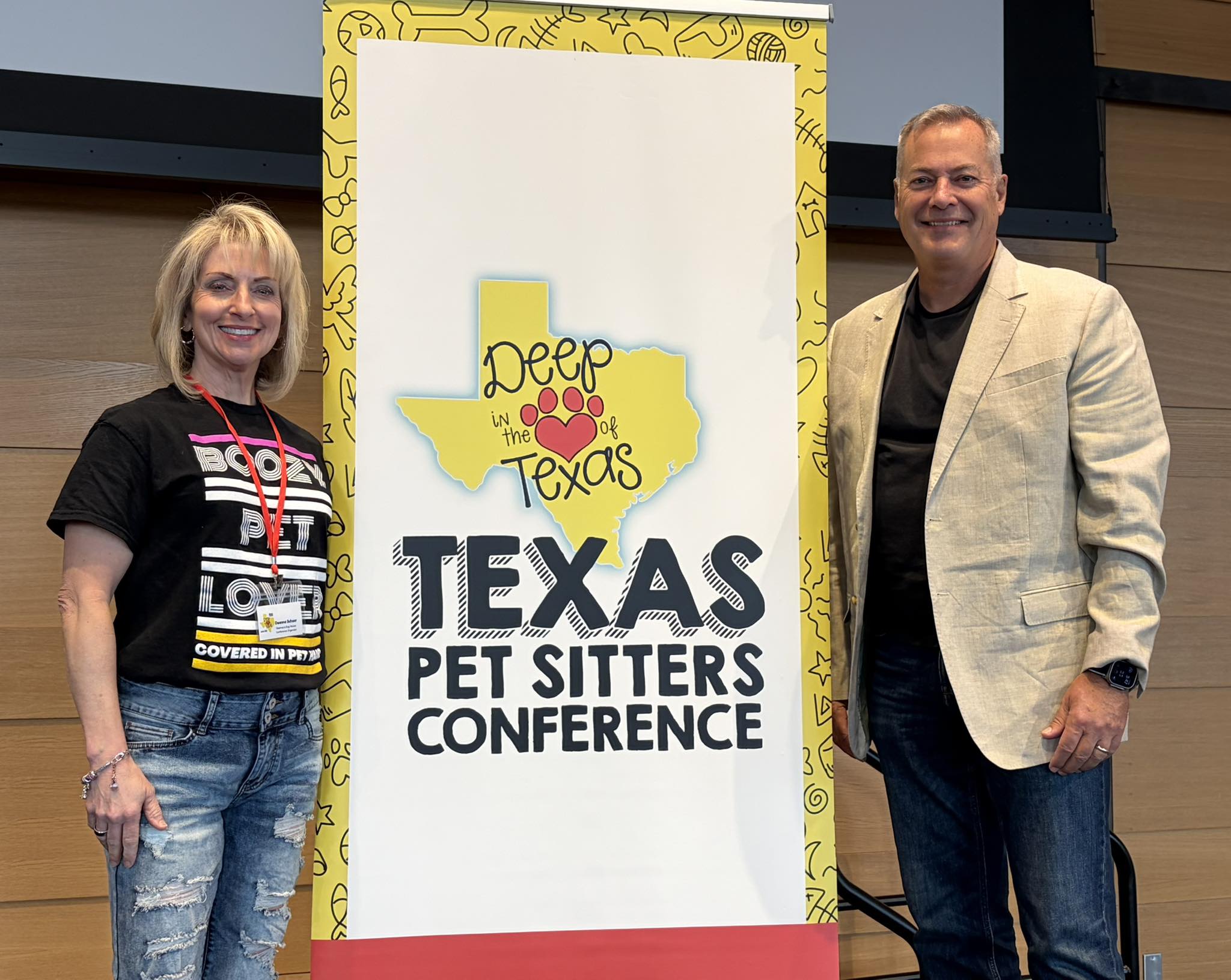 Speaker and attendee with conference banner